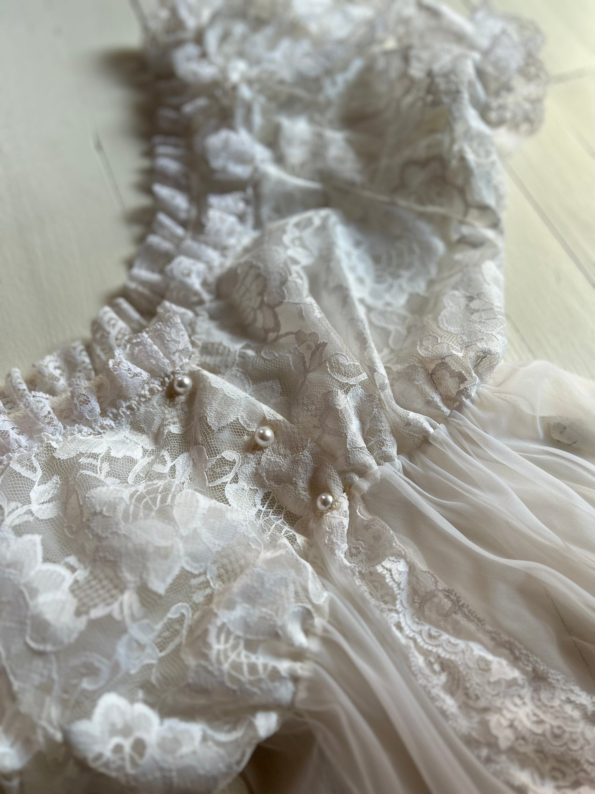 White sheer and lace lingerie on a light wooden floor