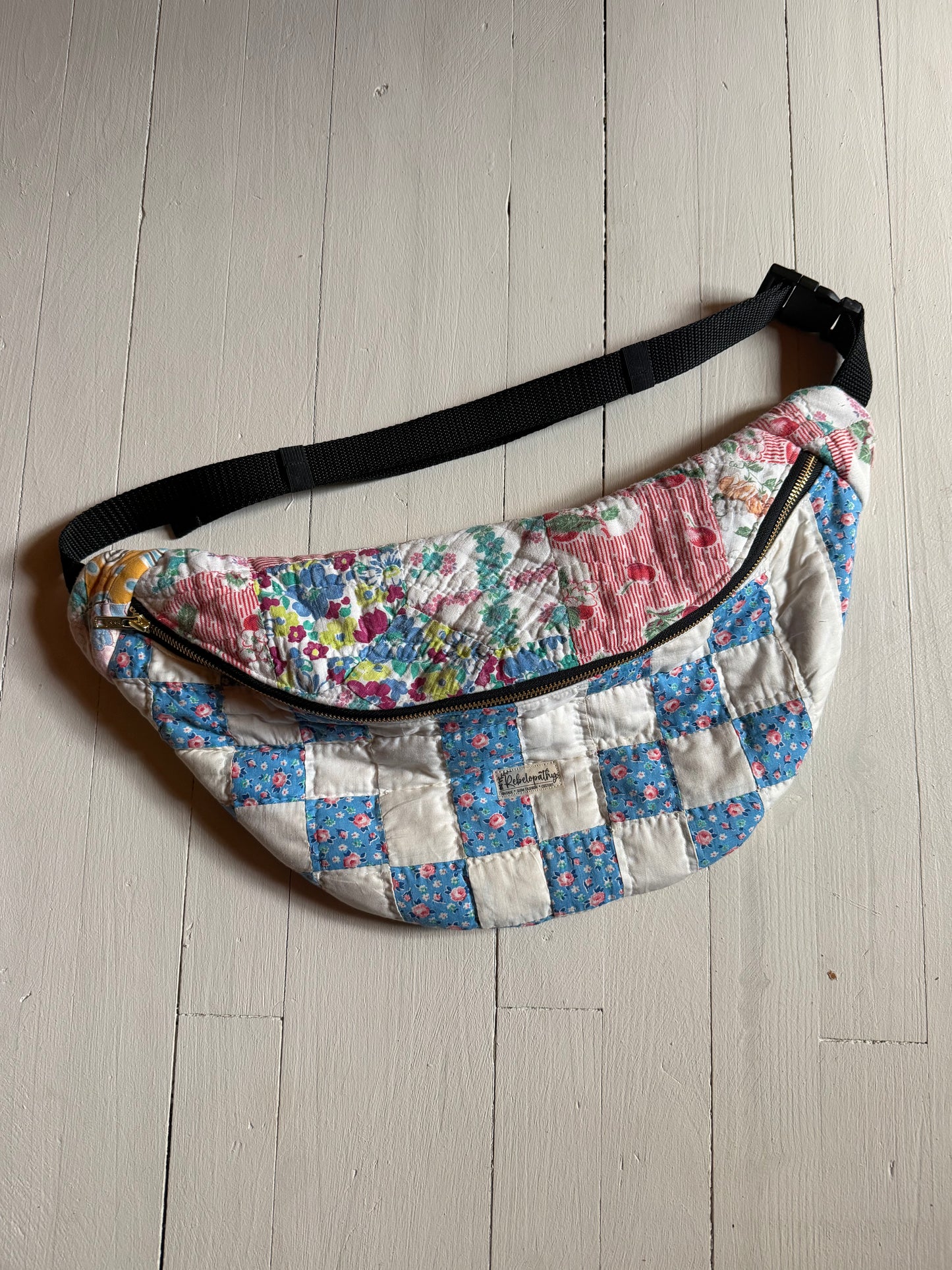 Floral patterned waist bag on a light wooden floor