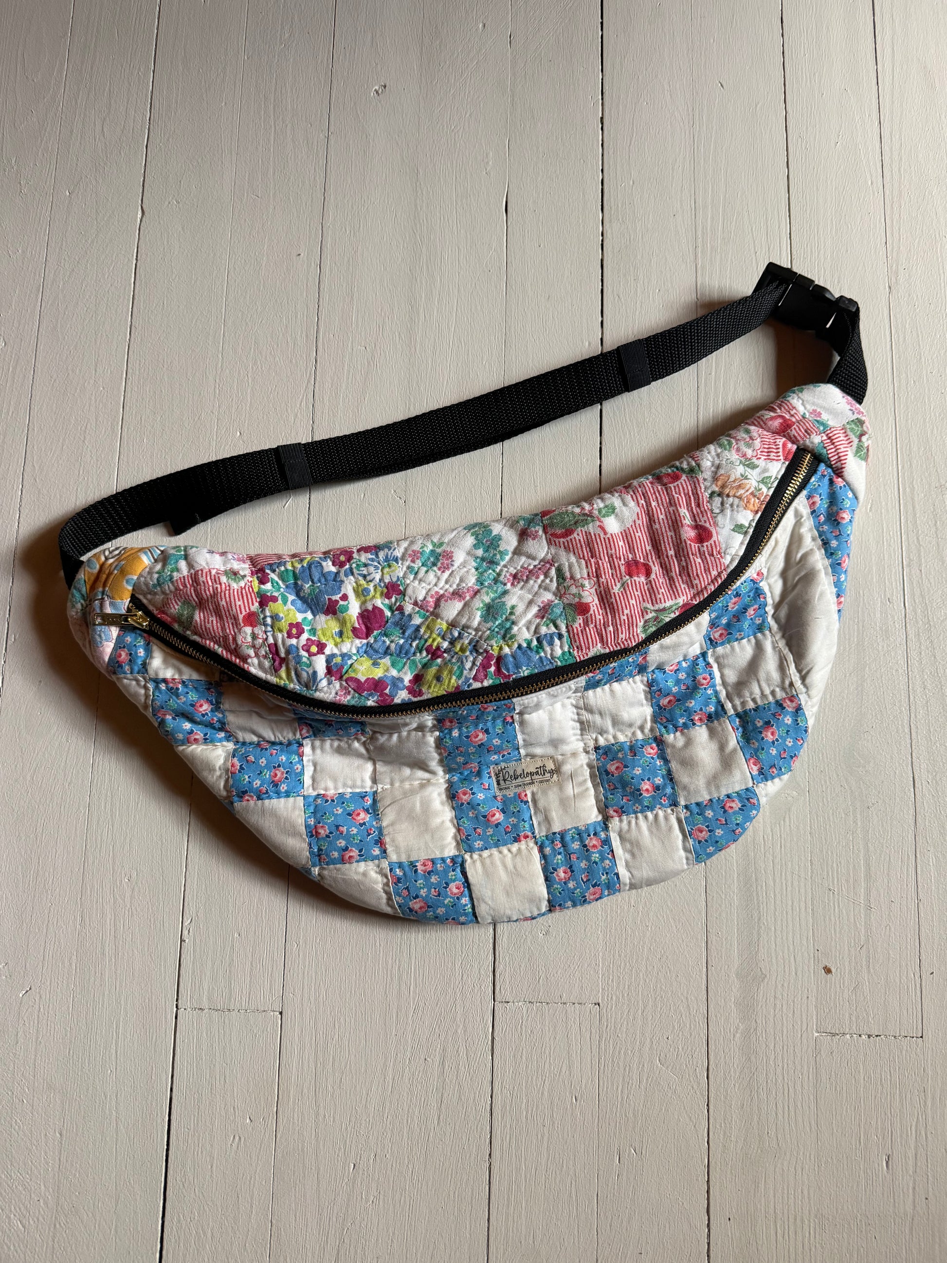 Floral patterned waist bag on a light wooden floor