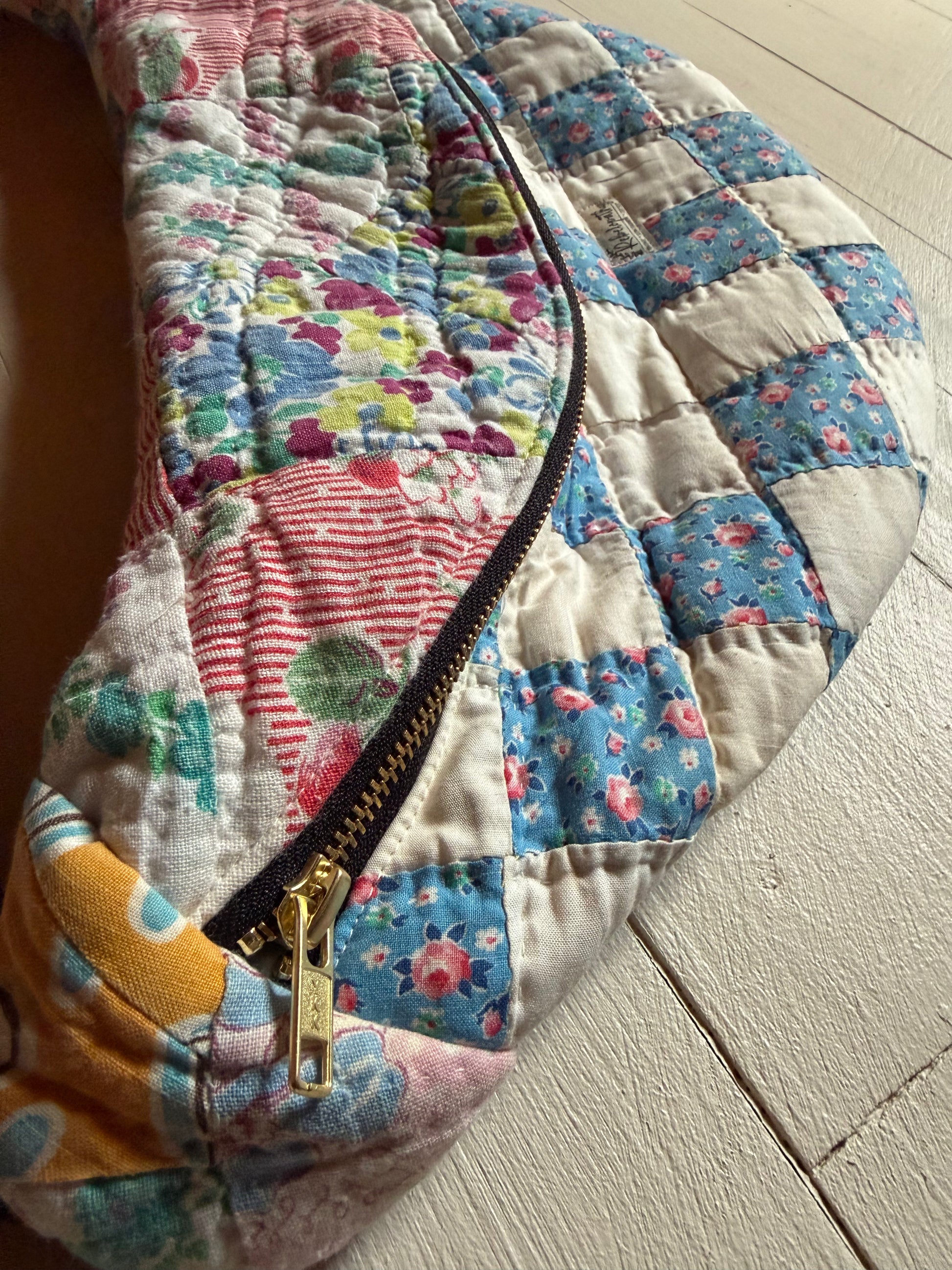 Floral quilt with a zipper on a wooden surface